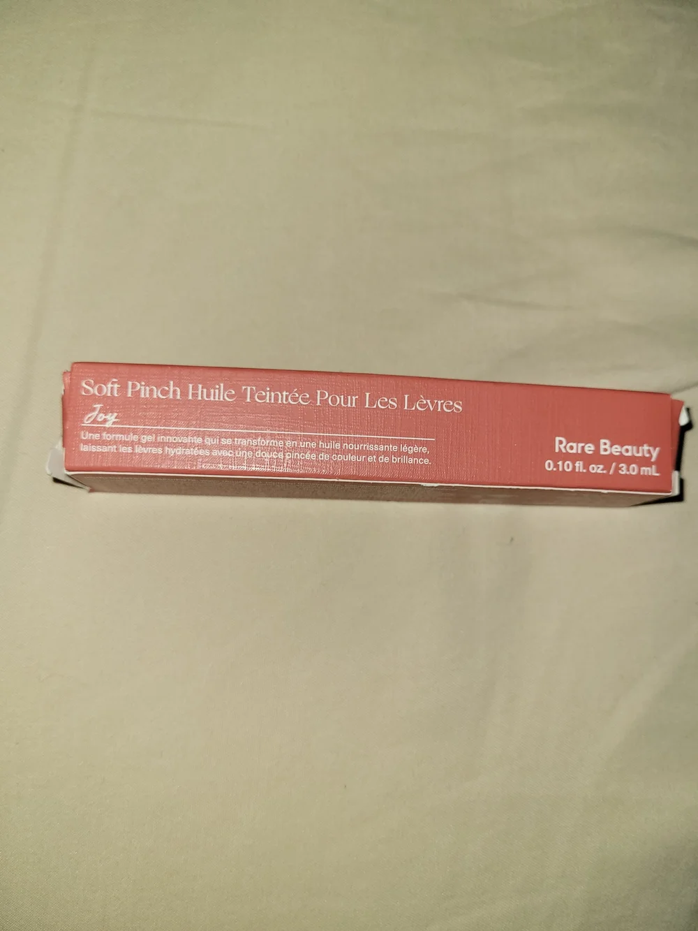 Rare Beauty Soft Pinch Tinted Lip Gloss — Joy (Warm Coral-Red)